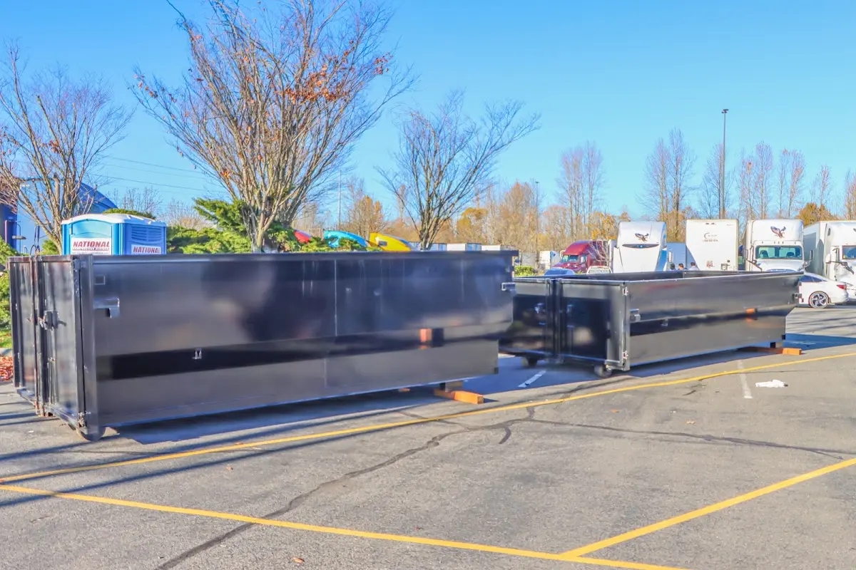 Professional dumpster rental service with roll-off container on residential driveway in World Golf Village